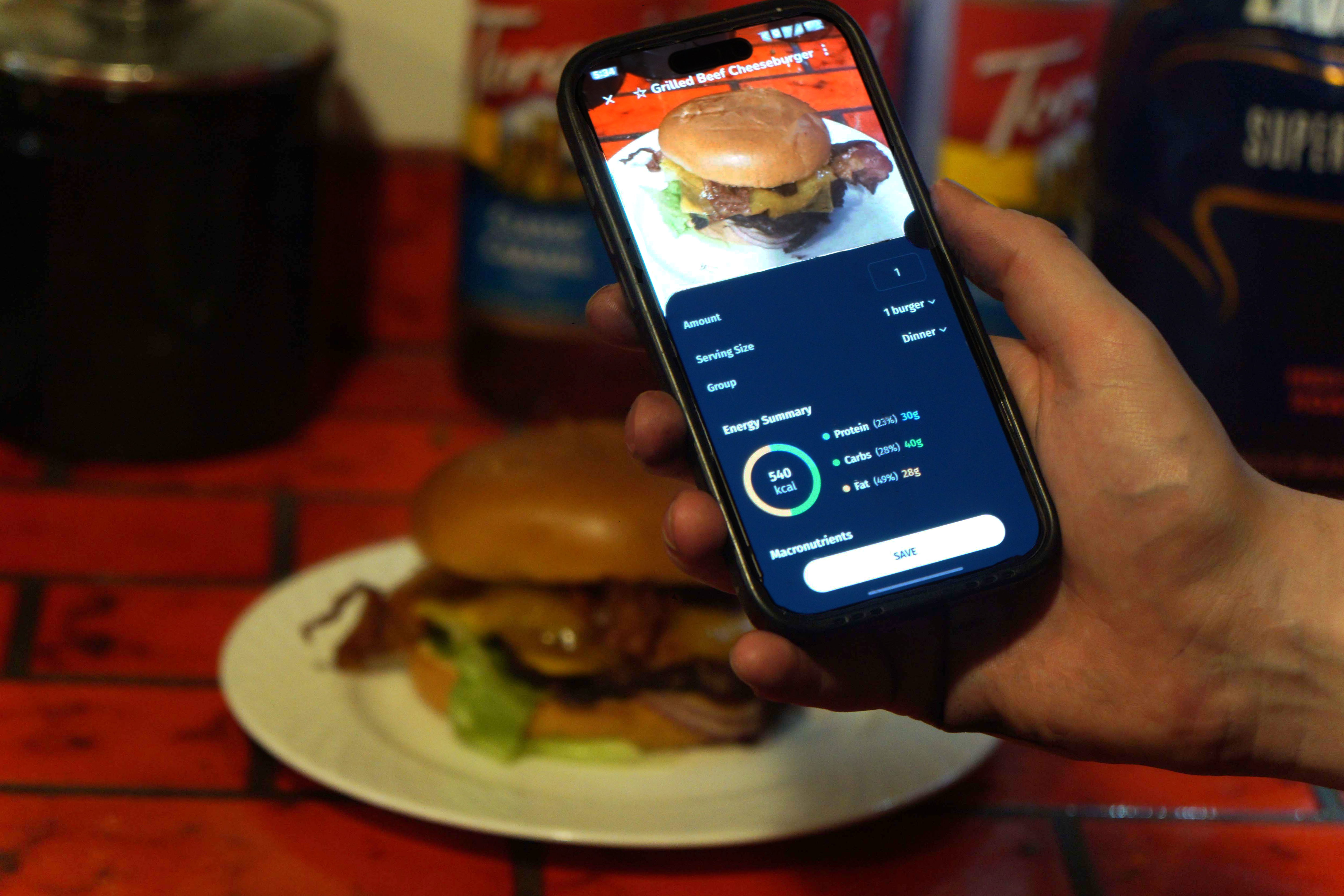 Burger photo with phone showing nutrition data